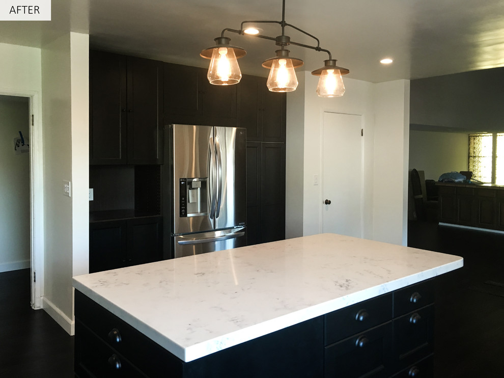 Inspiration for a mid-sized contemporary l-shaped dark wood floor eat-in kitchen remodel in Los Angeles with an undermount sink, black cabinets, quartz countertops, gray backsplash, subway tile backsplash, stainless steel appliances, an island and glass-front cabinets