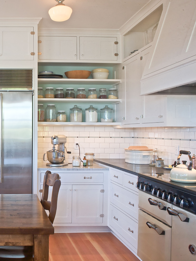 Inspiration for a timeless kitchen remodel in Seattle with white appliances, open cabinets, white cabinets, white backsplash and subway tile backsplash
