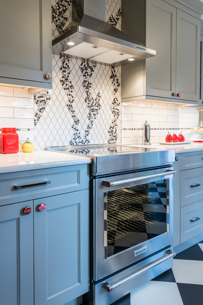 Medium sized traditional galley kitchen/diner in Seattle with a belfast sink, shaker cabinets, grey cabinets, engineered stone countertops, multi-coloured splashback, porcelain splashback, stainless steel appliances, vinyl flooring, no island and multi-coloured floors.