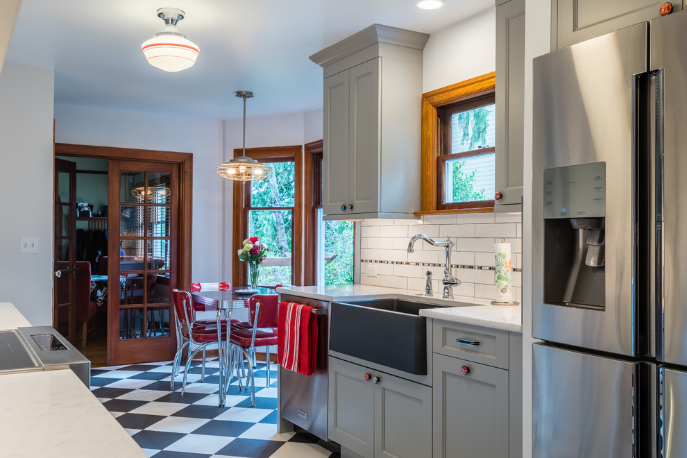 Eat-in kitchen - mid-sized transitional galley vinyl floor and multicolored floor eat-in kitchen idea in Seattle with a farmhouse sink, shaker cabinets, gray cabinets, quartz countertops, multicolored backsplash, porcelain backsplash, stainless steel appliances and no island