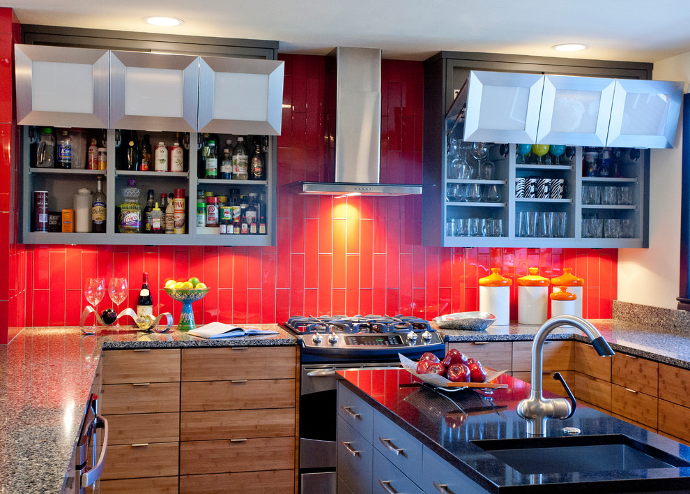 Example of a trendy u-shaped eat-in kitchen design in Kansas City with stainless steel appliances, an undermount sink, flat-panel cabinets, medium tone wood cabinets, red backsplash, quartz countertops and glass tile backsplash