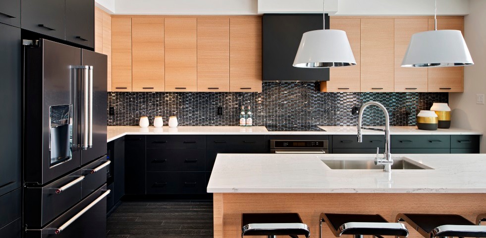 This is an example of a large modern l-shaped kitchen in Ottawa with a submerged sink, flat-panel cabinets, light wood cabinets, quartz worktops, black splashback, glass tiled splashback, stainless steel appliances, dark hardwood flooring and an island.