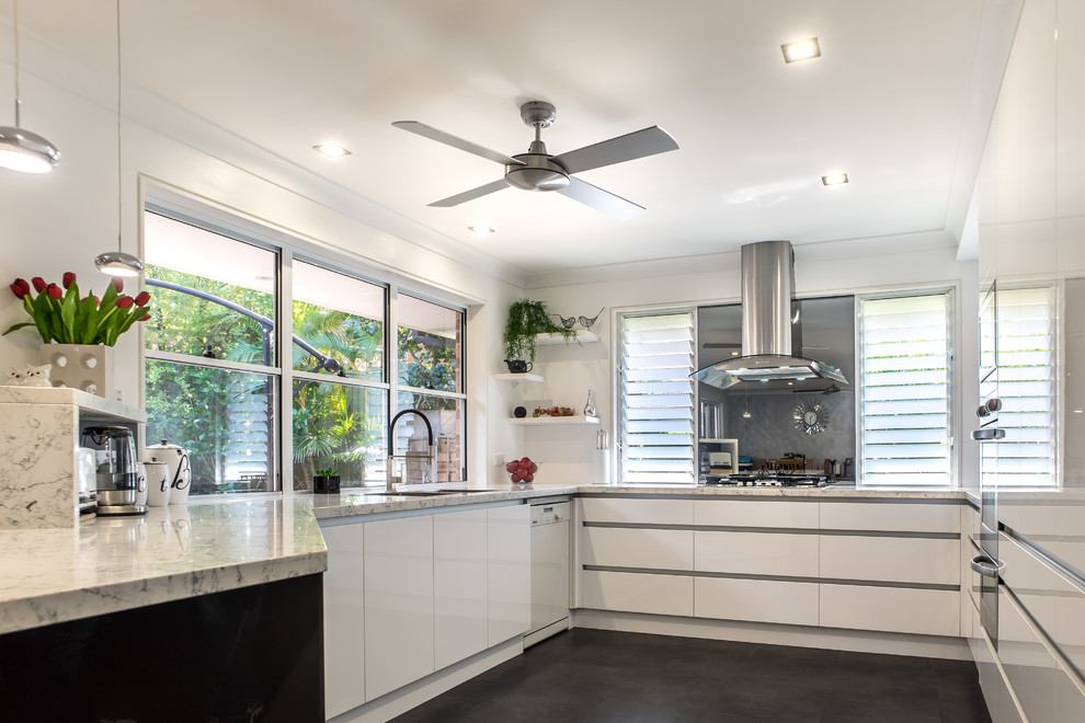 Minimalist u-shaped open concept kitchen photo in Sydney with flat-panel cabinets, white cabinets, glass sheet backsplash and a peninsula