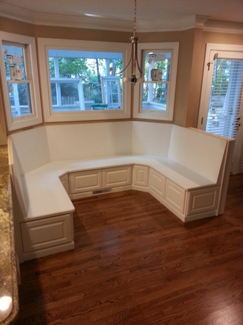 Inspiration for a timeless u-shaped medium tone wood floor kitchen remodel in Raleigh with raised-panel cabinets, white cabinets and wood countertops