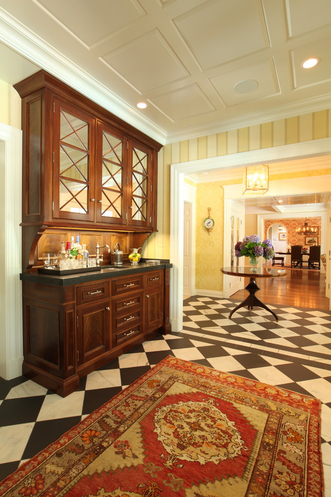 Inspiration for a traditional kitchen in Louisville with glass-front cabinets and dark wood cabinets.