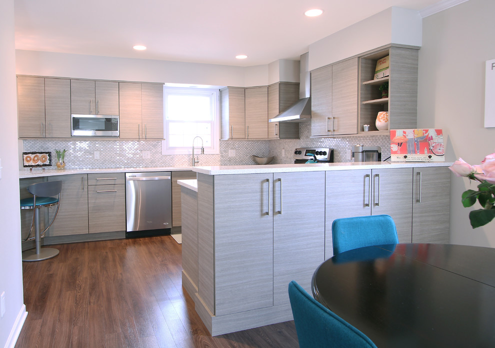 Small transitional u-shaped vinyl floor open concept kitchen photo in Other with an undermount sink, flat-panel cabinets, gray cabinets, quartz countertops, multicolored backsplash, marble backsplash, stainless steel appliances and a peninsula