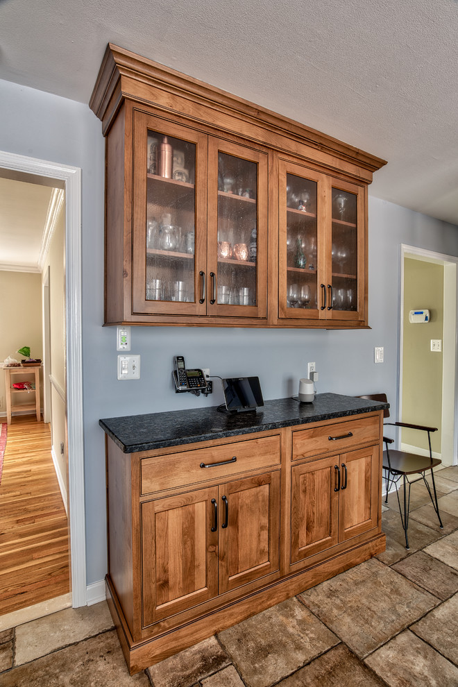 Mid-sized urban l-shaped ceramic tile and brown floor eat-in kitchen photo in New York with an undermount sink, beaded inset cabinets, medium tone wood cabinets, granite countertops, gray backsplash, slate backsplash, stainless steel appliances and an island