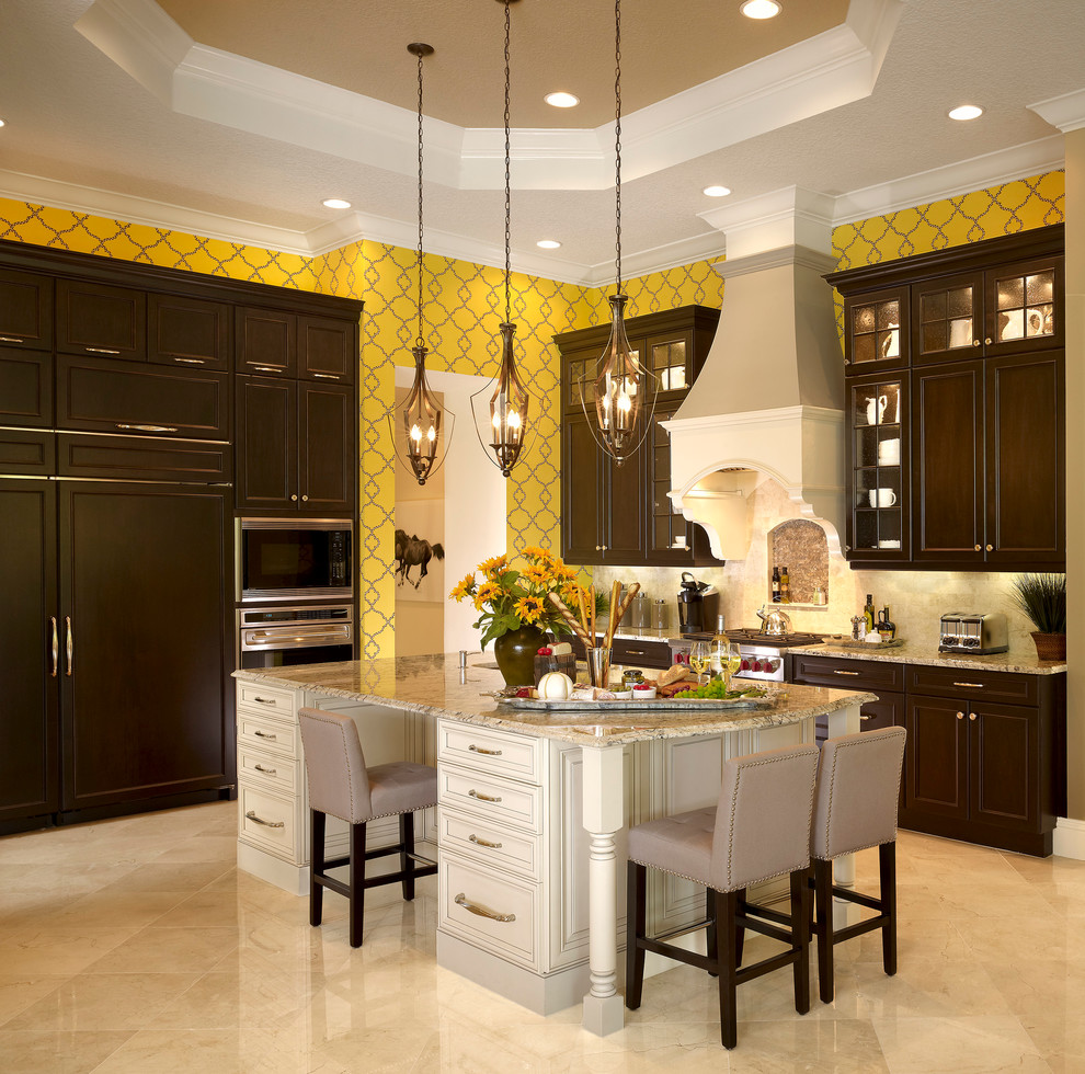Inspiration for a mid-sized timeless u-shaped eat-in kitchen remodel in Tampa with dark wood cabinets, beige backsplash, stainless steel appliances, an island, an undermount sink, beaded inset cabinets, granite countertops and ceramic backsplash