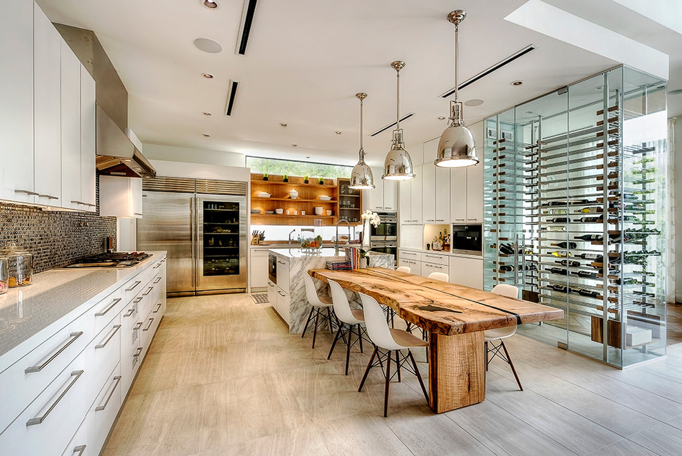 Example of a mid-sized minimalist u-shaped light wood floor and beige floor open concept kitchen design in Houston with an undermount sink, flat-panel cabinets, white cabinets, marble countertops, blue backsplash, mosaic tile backsplash, stainless steel appliances and an island