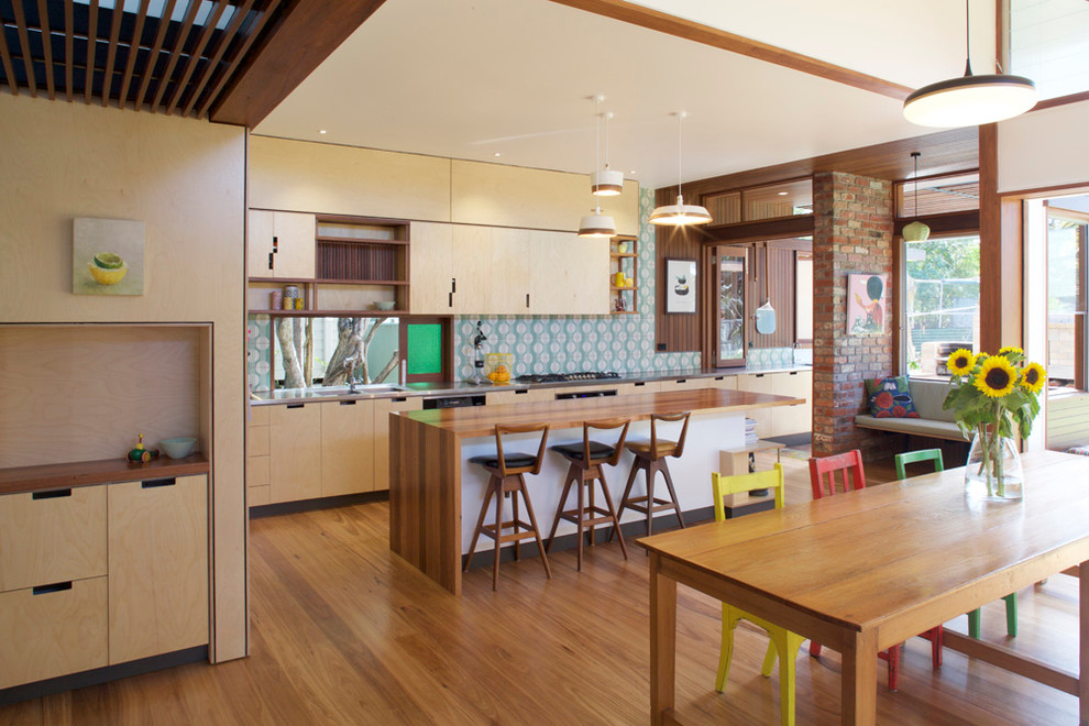 Eat-in kitchen - mid-sized contemporary galley light wood floor eat-in kitchen idea in Brisbane with a double-bowl sink, light wood cabinets, wood countertops, green backsplash, cement tile backsplash, stainless steel appliances and an island