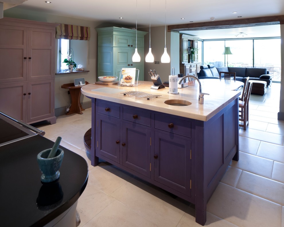 Example of a transitional enclosed kitchen design in Gloucestershire with an undermount sink, stone slab backsplash and an island