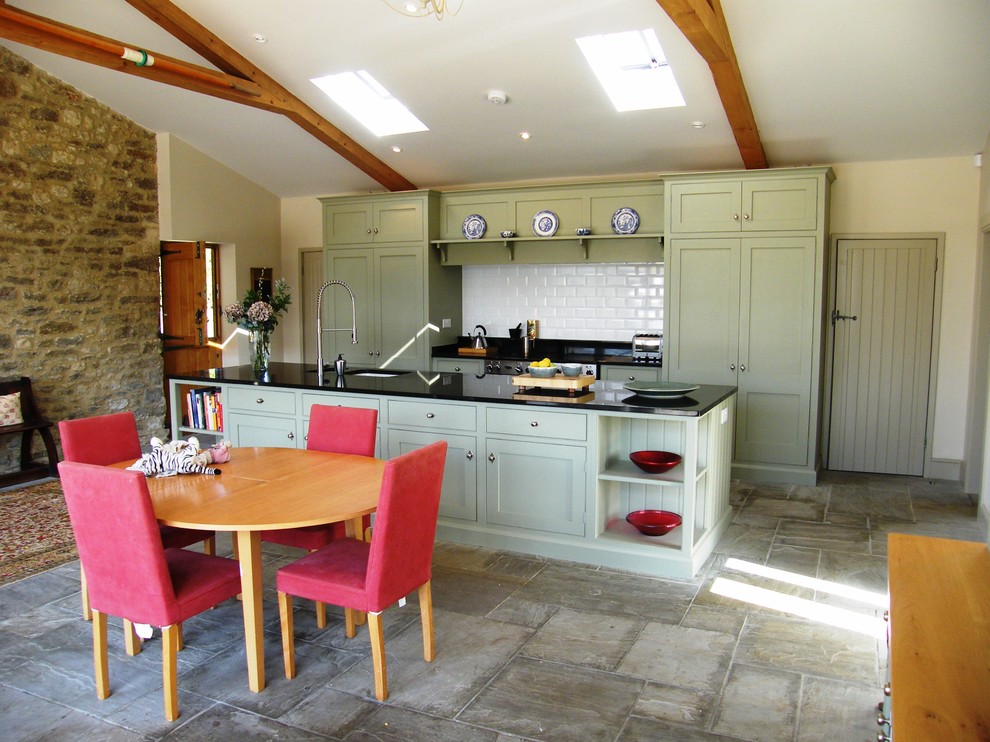 Rural galley kitchen/diner in Dorset with shaker cabinets and green cabinets.