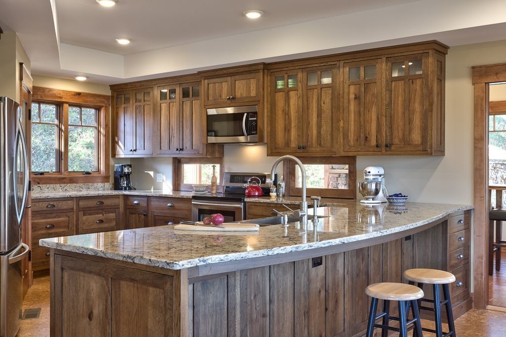 Eat-in kitchen - mid-sized craftsman u-shaped cork floor and brown floor eat-in kitchen idea in Other with a farmhouse sink, shaker cabinets, dark wood cabinets, granite countertops, stainless steel appliances and a peninsula