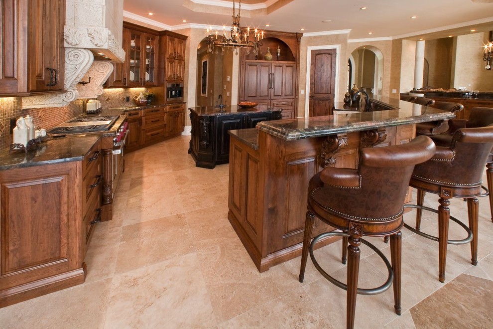Elegant kitchen photo in Atlanta with raised-panel cabinets, dark wood cabinets, brown backsplash and paneled appliances