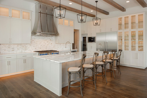 Spacious kitchen with wholesale white shaker RTA cabinets and marble island countertop