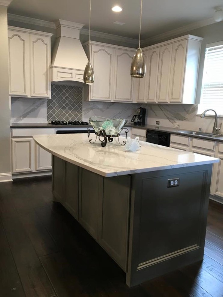 Inspiration for a large traditional l-shaped open plan kitchen in Dallas with a double-bowl sink, recessed-panel cabinets, white cabinets, grey splashback, ceramic splashback, stainless steel appliances, dark hardwood flooring and an island.