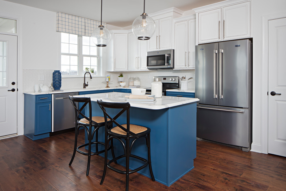Inspiration for a classic l-shaped kitchen in Baltimore with recessed-panel cabinets, white cabinets, white splashback, stainless steel appliances, dark hardwood flooring and an island.