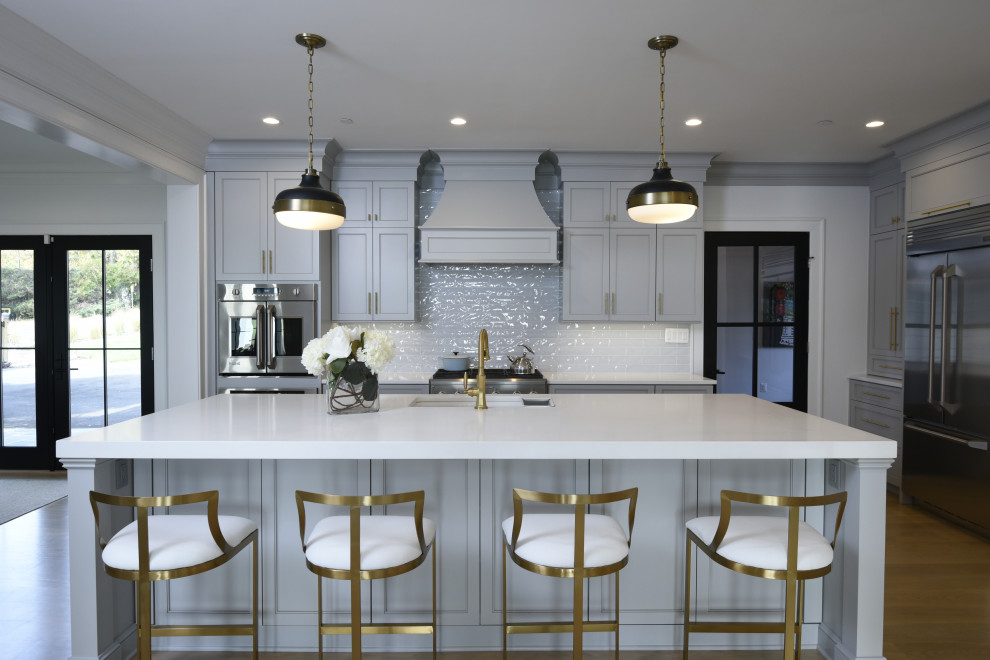 Photo of a classic kitchen in Baltimore with flat-panel cabinets, grey cabinets, grey splashback, ceramic splashback, an island and white worktops.