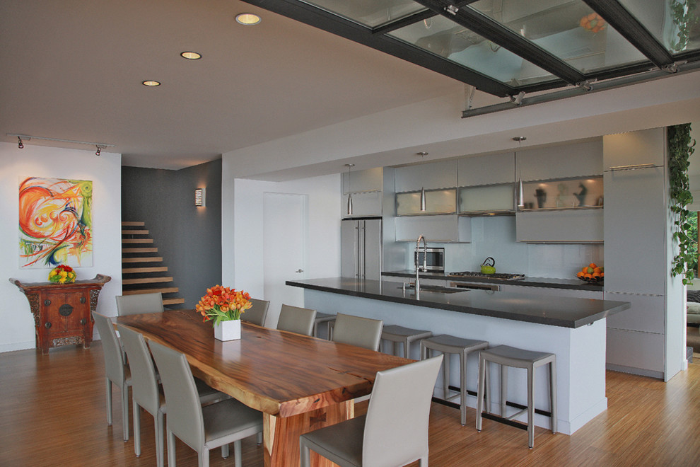Photo of a contemporary kitchen in DC Metro with flat-panel cabinets and stainless steel appliances.