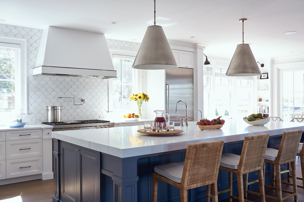 Inspiration for a nautical kitchen/diner in New York with recessed-panel cabinets, white cabinets, white splashback, stainless steel appliances, dark hardwood flooring, an island and white worktops.