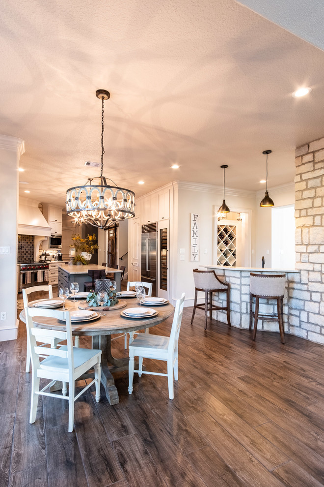 Inspiration for a large galley porcelain tile and brown floor eat-in kitchen remodel in Houston with a farmhouse sink, shaker cabinets, white cabinets, quartzite countertops, multicolored backsplash, stone tile backsplash, stainless steel appliances, an island and multicolored countertops