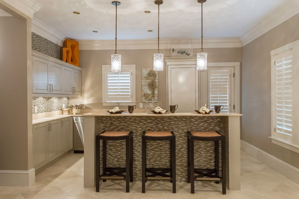 This is an example of a small traditional l-shaped kitchen/diner in Miami with a submerged sink, shaker cabinets, beige cabinets, engineered stone countertops, multi-coloured splashback, matchstick tiled splashback, stainless steel appliances, travertine flooring, an island and beige floors.