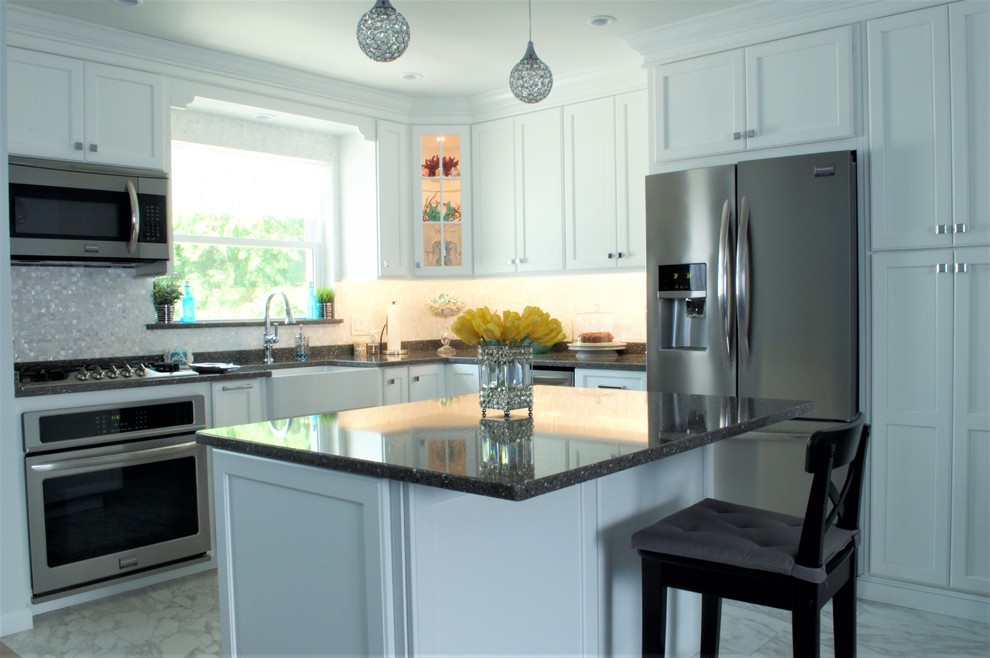 Inspiration for a medium sized classic l-shaped kitchen in New York with a belfast sink, white cabinets, quartz worktops, multi-coloured splashback, stainless steel appliances, an island, shaker cabinets and grey worktops.