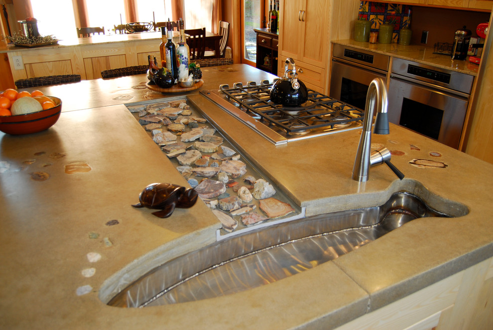 Photo of a large traditional l-shaped kitchen/diner in Seattle with a submerged sink, shaker cabinets, light wood cabinets, concrete worktops, stainless steel appliances, medium hardwood flooring and an island.