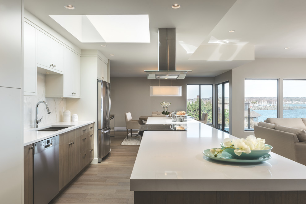 Example of a mid-sized trendy single-wall light wood floor eat-in kitchen design in Vancouver with a double-bowl sink, beaded inset cabinets, distressed cabinets, quartzite countertops, white backsplash, stone slab backsplash, stainless steel appliances and an island