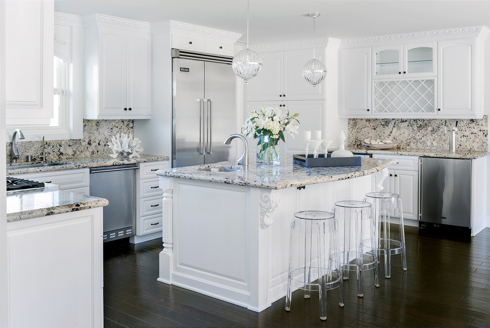 Photo of a medium sized coastal u-shaped kitchen in Santa Barbara with raised-panel cabinets, white cabinets, multi-coloured splashback, stainless steel appliances, dark hardwood flooring, an island and granite worktops.