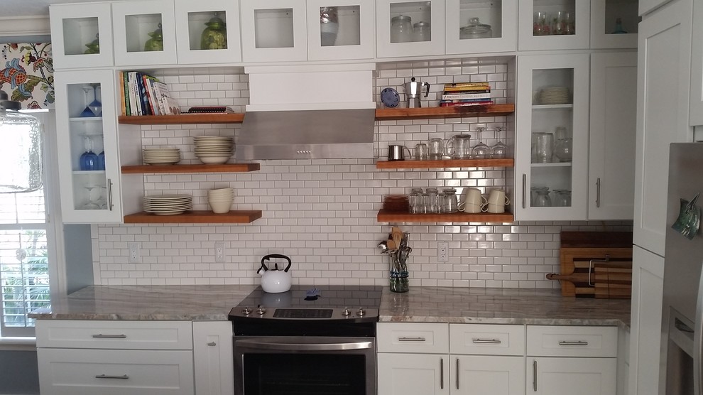 Eat-in kitchen - large coastal single-wall porcelain tile eat-in kitchen idea in Miami with a single-bowl sink, shaker cabinets, white cabinets, quartzite countertops, yellow backsplash, subway tile backsplash, white appliances and an island