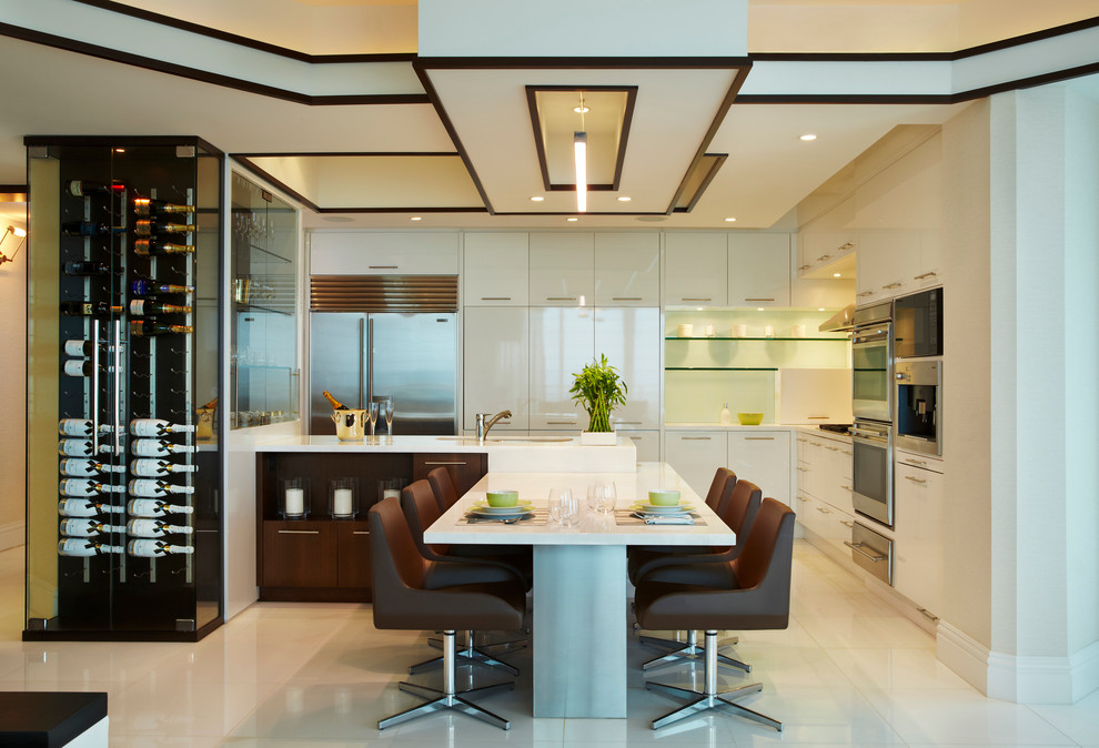 Example of a beach style kitchen design in New York with flat-panel cabinets and stainless steel appliances