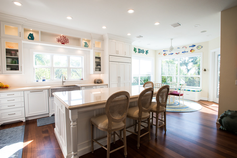 Mid-sized beach style u-shaped medium tone wood floor eat-in kitchen photo in Miami with an undermount sink, shaker cabinets, white cabinets, stainless steel appliances and an island