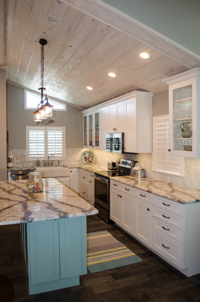 Open concept kitchen - mid-sized coastal u-shaped dark wood floor open concept kitchen idea in Tampa with a farmhouse sink, white cabinets, white backsplash, stainless steel appliances, an island, shaker cabinets, marble countertops and porcelain backsplash