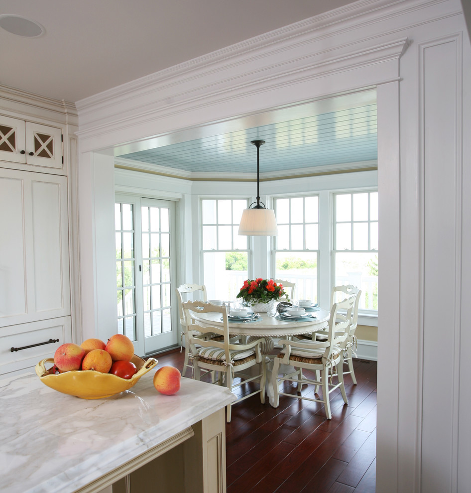 Example of a beach style eat-in kitchen design in Philadelphia with recessed-panel cabinets and white cabinets