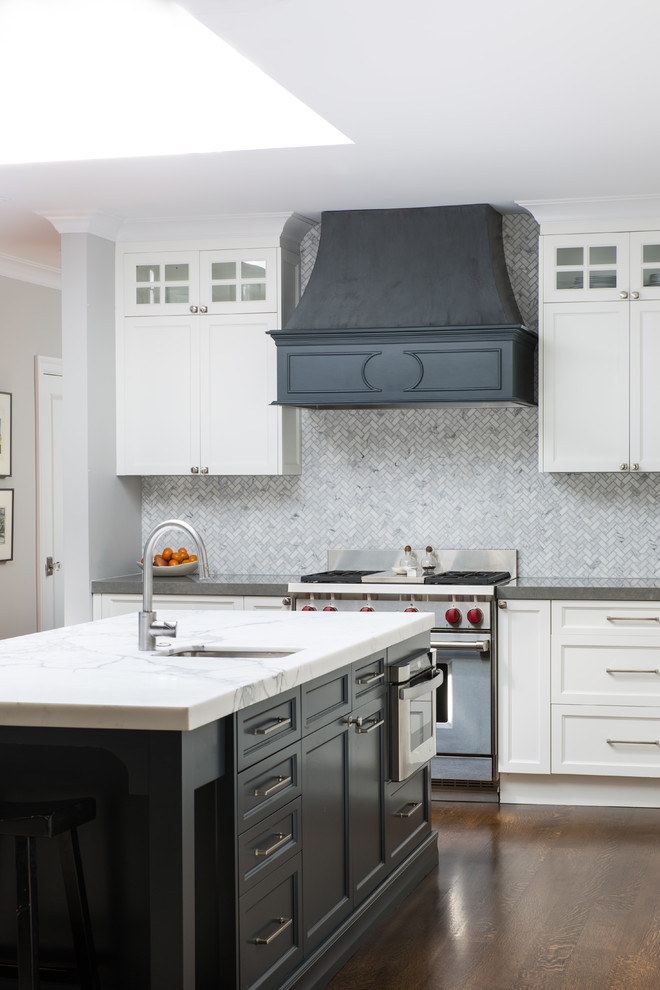 Medium sized traditional l-shaped kitchen in San Francisco with an island, shaker cabinets, white cabinets, soapstone worktops, grey splashback, mosaic tiled splashback, stainless steel appliances, dark hardwood flooring, brown floors and a belfast sink.