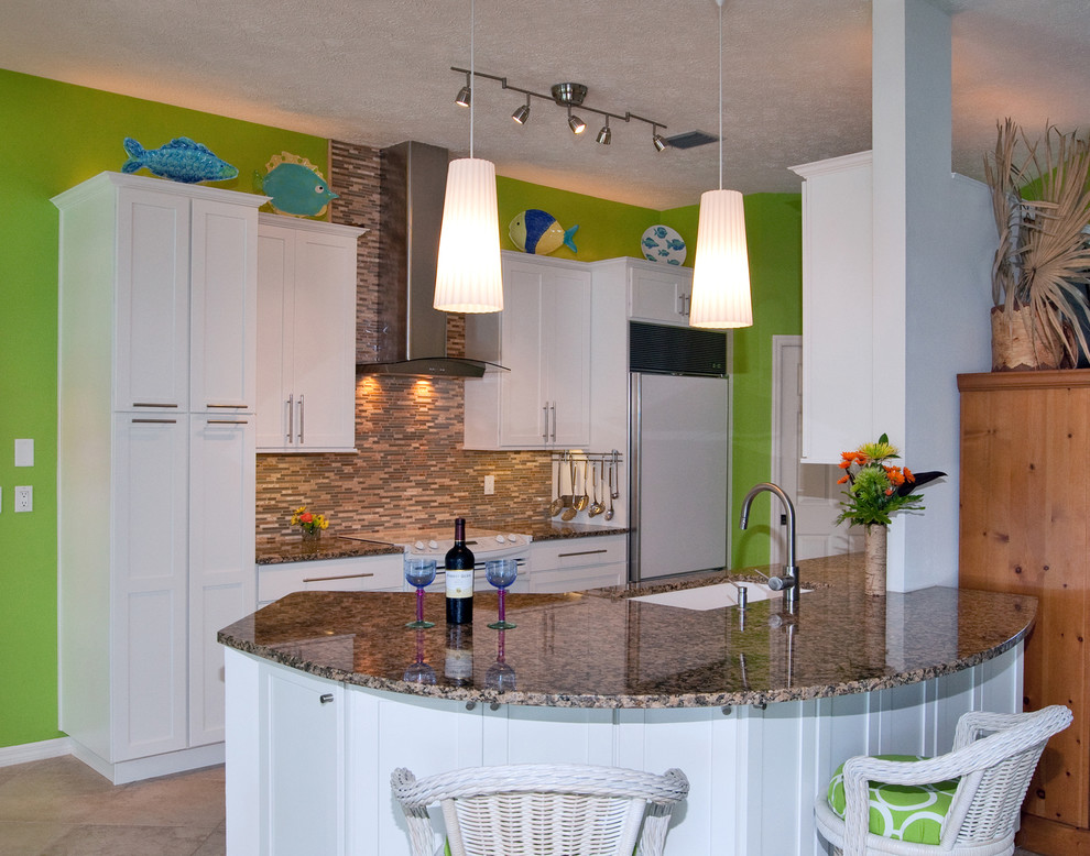 Mid-sized beach style galley ceramic tile eat-in kitchen photo in Tampa with an undermount sink, shaker cabinets, white cabinets, granite countertops, brown backsplash and white appliances