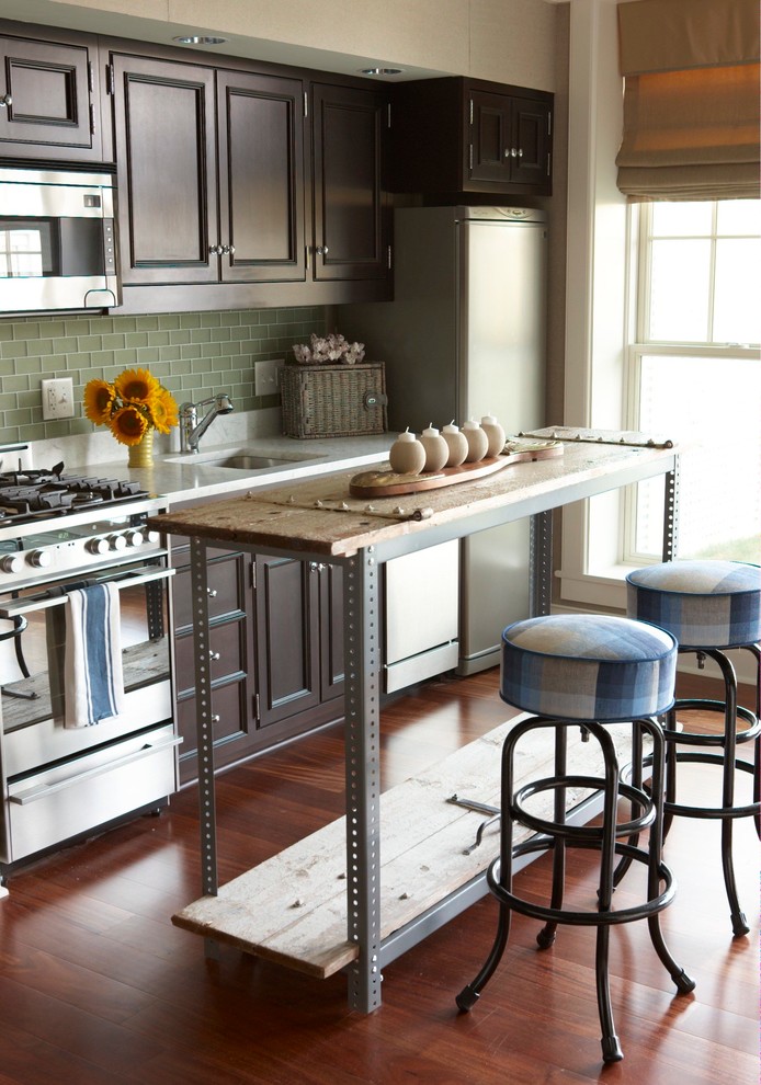 Immagine di una cucina boho chic con lavello sottopiano, ante con riquadro incassato, ante in legno bruno, paraspruzzi verde e elettrodomestici in acciaio inossidabile