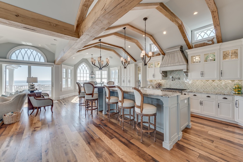 Expansive nautical kitchen/diner in Philadelphia with flat-panel cabinets, white cabinets, granite worktops, grey splashback, porcelain splashback, integrated appliances and an island.