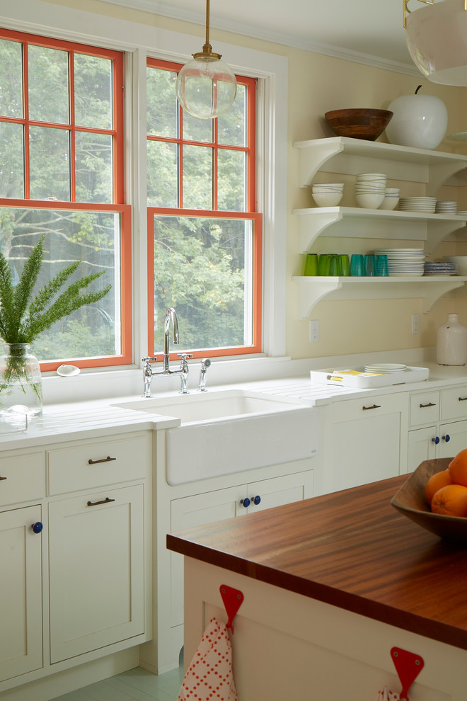 Mid-sized beach style single-wall painted wood floor and gray floor eat-in kitchen photo in Portland Maine with recessed-panel cabinets, white cabinets, wood countertops, paneled appliances and an island