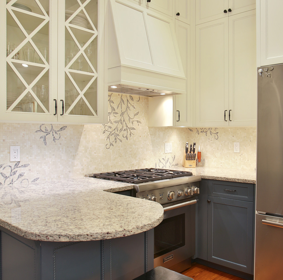 Example of a small transitional l-shaped medium tone wood floor and brown floor open concept kitchen design in Boston with recessed-panel cabinets, gray cabinets, granite countertops, beige backsplash, mosaic tile backsplash, stainless steel appliances, a peninsula and beige countertops