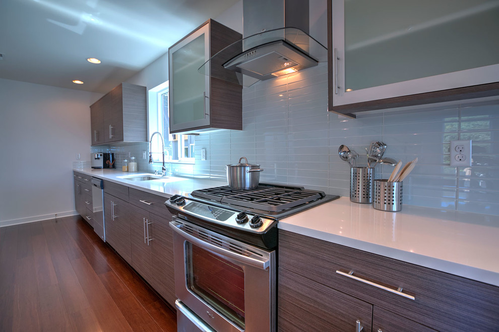 Small trendy galley bamboo floor and brown floor eat-in kitchen photo in Seattle with an undermount sink, flat-panel cabinets, quartz countertops, white backsplash, subway tile backsplash, stainless steel appliances, an island and light wood cabinets