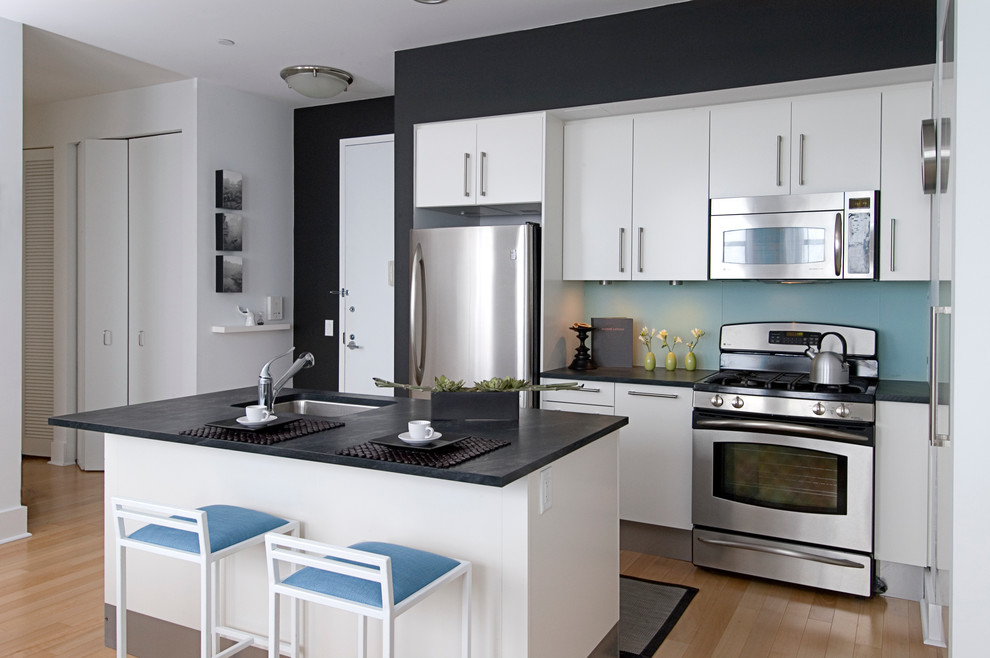 Example of a trendy kitchen design in New York with an undermount sink, flat-panel cabinets and white cabinets