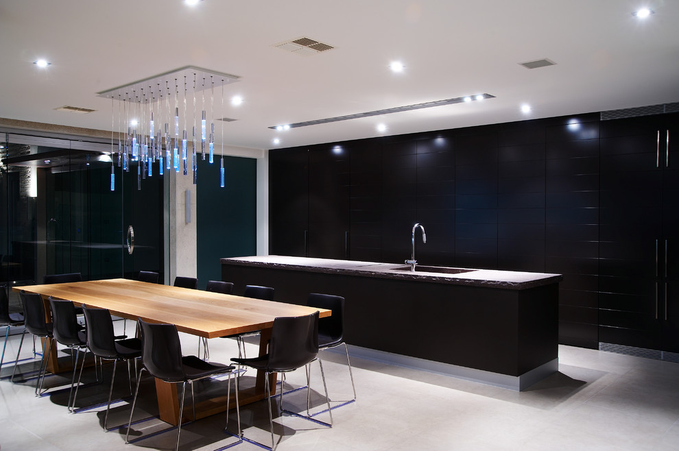 Large minimalist single-wall ceramic tile eat-in kitchen photo in Melbourne with a drop-in sink, flat-panel cabinets, dark wood cabinets, marble countertops, stainless steel appliances and an island