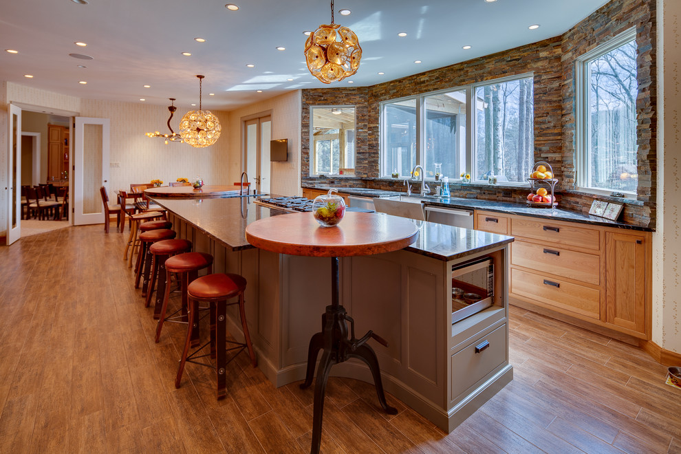 Inspiration for a large transitional single-wall dark wood floor eat-in kitchen remodel in DC Metro with recessed-panel cabinets, medium tone wood cabinets, an island, granite countertops, brown backsplash, matchstick tile backsplash, stainless steel appliances and a farmhouse sink