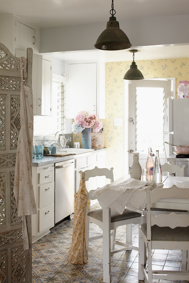 Inspiration for a small shabby-chic style galley ceramic tile enclosed kitchen remodel in Los Angeles with white cabinets, no island, a drop-in sink and flat-panel cabinets