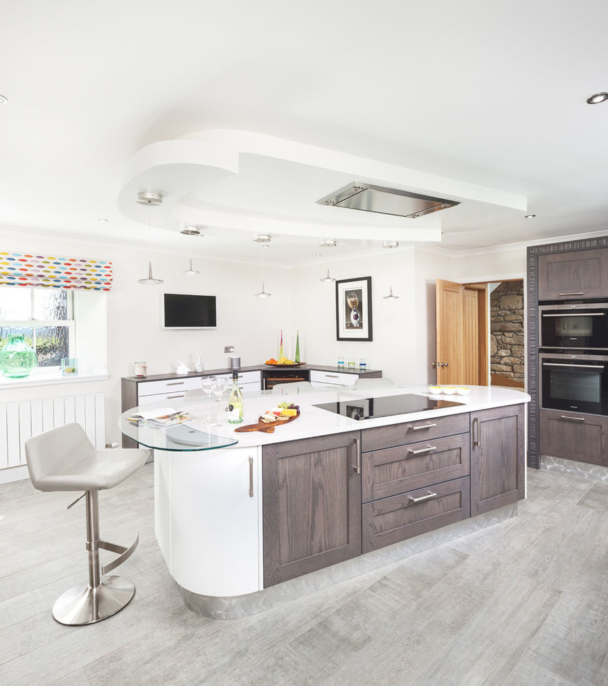 Traditional kitchen in Edinburgh with shaker cabinets, white cabinets and an island.