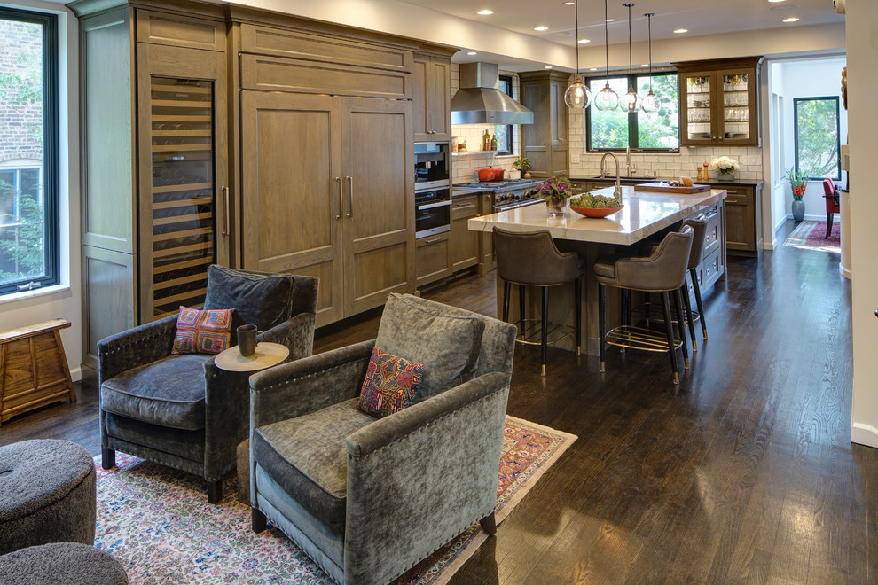 Example of a large transitional l-shaped dark wood floor and brown floor eat-in kitchen design in Chicago with an undermount sink, flat-panel cabinets, medium tone wood cabinets, quartzite countertops, white backsplash, ceramic backsplash, paneled appliances, an island and white countertops