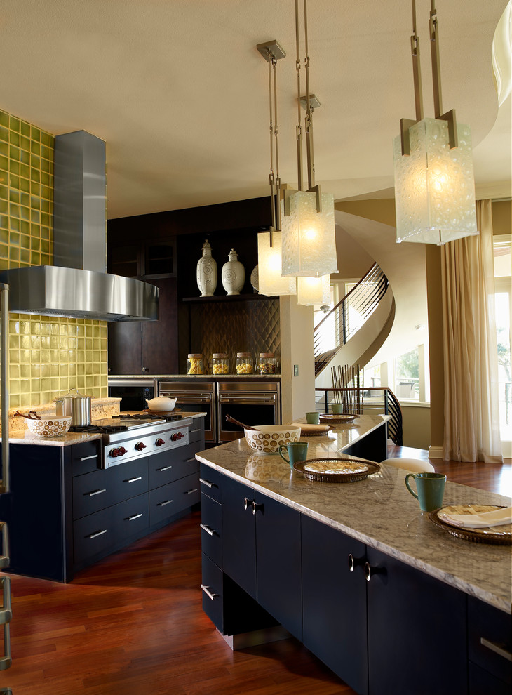 Inspiration for a medium sized contemporary galley kitchen/diner in Tampa with flat-panel cabinets, beige cabinets, granite worktops, green splashback, porcelain splashback, stainless steel appliances, dark hardwood flooring, an island and brown floors.