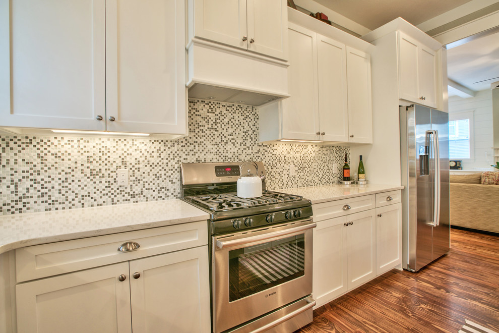 Example of a large arts and crafts l-shaped eat-in kitchen design in Atlanta with multicolored backsplash, stainless steel appliances and an island